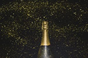 bottle-champagne-flying-golden-glitters bottle-champagne-flying-golden-glitters