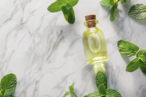 essential-oil-bottle-mint-leaves-marble-background essential-oil-bottle-mint-leaves-marble-background