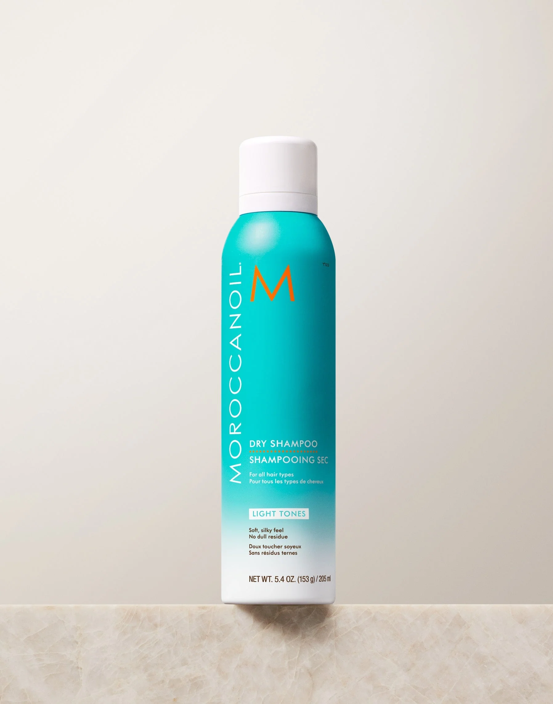 Moroccanoil Dry Shampoo Light Tones bočica na kamenoj podlozi